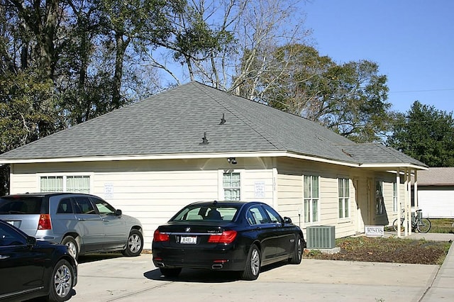 104 Longstreet Rd, Willis, TX 77378 - view of home's exterior with roof with shingles and central AC unit