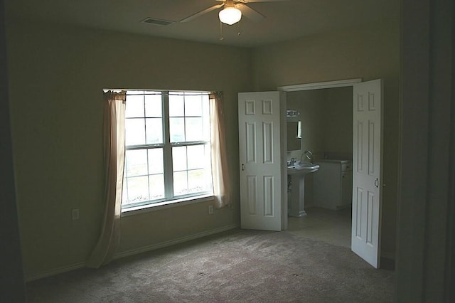 104 Longstreet Rd, Willis, TX 77378 - unfurnished bedroom with carpet floors, baseboards, and ensuite bathroom