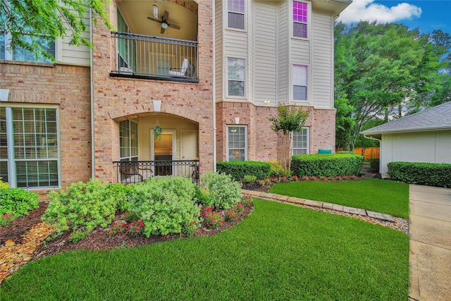6607 Lake Woodlands Dr Unit 612, The Woodlands, TX 77382 - doorway to property with a balcony, a lawn, brick siding, and a ceiling fan