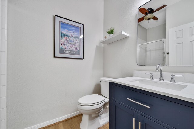 6607 Lake Woodlands Dr Unit 612, The Woodlands, TX 77382 - full bath featuring ceiling fan, wood finished floors, a shower stall, baseboards, and toilet