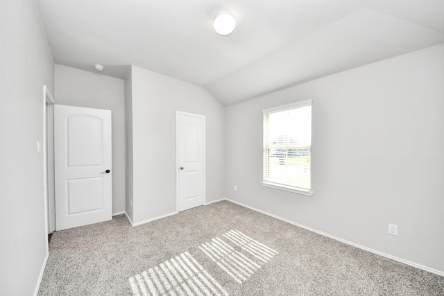 4727 Lombardy Fire Trl, Katy, TX 77449 - unfurnished bedroom featuring carpet floors, baseboards, and lofted ceiling