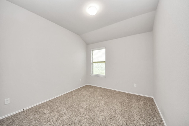 4727 Lombardy Fire Trl, Katy, TX 77449 - empty room featuring carpet floors, lofted ceiling, and baseboards