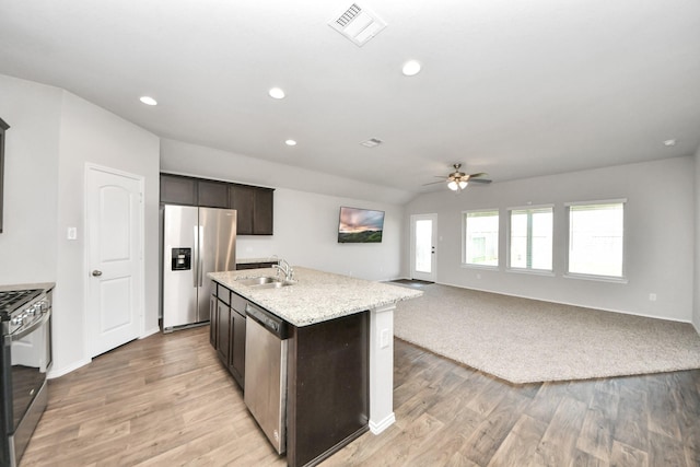 4727 Lombardy Fire Trl, Katy, TX 77449 - kitchen featuring appliances with stainless steel finishes, a sink, ceiling fan, light wood-style flooring, and open floor plan