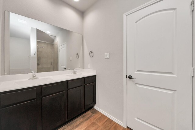4727 Lombardy Fire Trl, Katy, TX 77449 - bathroom with wood finished floors, a stall shower, double vanity, baseboards, and recessed lighting