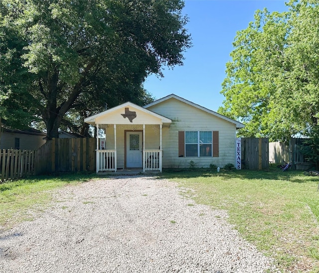 view of front of house with a porch and gravel driveway
