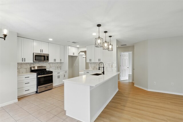 5318 Cilantro Ln, Baytown, TX 77521 - kitchen with stainless steel appliances, a sink, a peninsula, light countertops, and tasteful backsplash