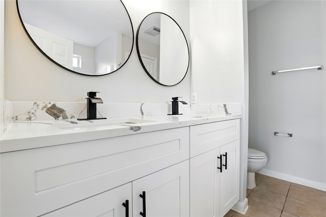 5318 Cilantro Ln, Baytown, TX 77521 - full bathroom with tile patterned floors, toilet, double vanity, and baseboards
