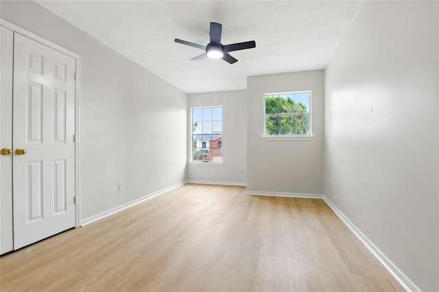 5318 Cilantro Ln, Baytown, TX 77521 - unfurnished bedroom with light wood-style floors, baseboards, and ceiling fan