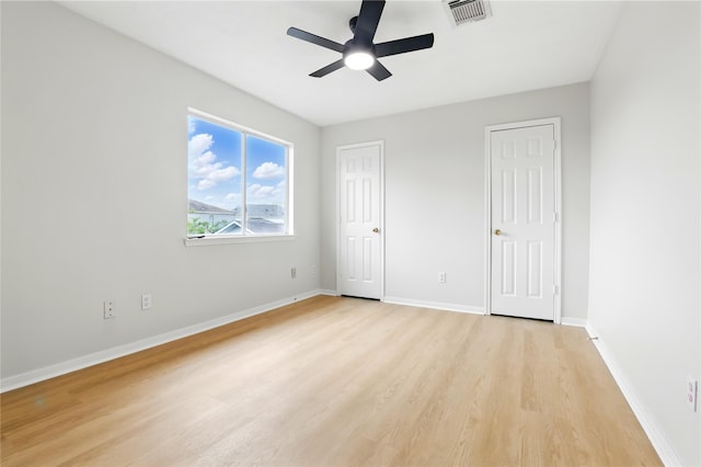 5318 Cilantro Ln, Baytown, TX 77521 - unfurnished bedroom with light wood finished floors, baseboards, and a ceiling fan