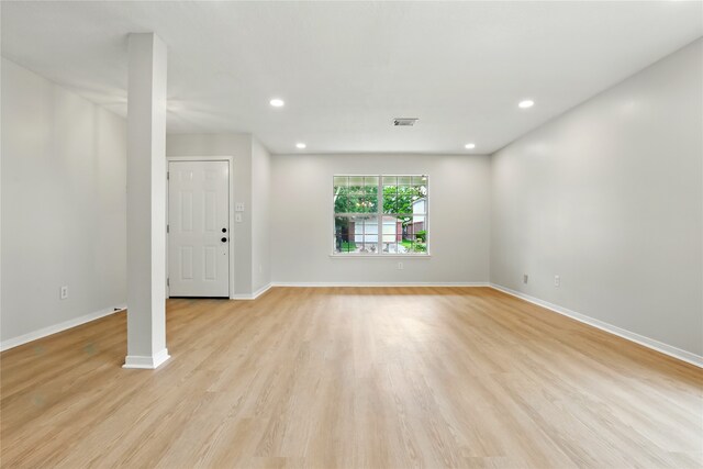 5318 Cilantro Ln, Baytown, TX 77521 - unfurnished living room with baseboards, light wood-type flooring, and recessed lighting