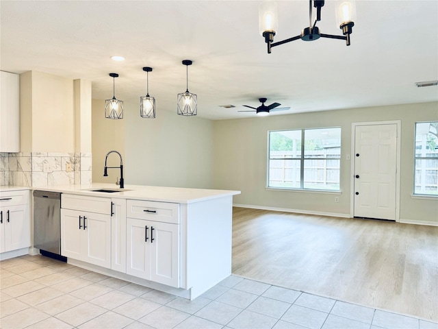 5318 Cilantro Ln, Baytown, TX 77521 - kitchen with a sink, dishwasher, open floor plan, a peninsula, and light countertops