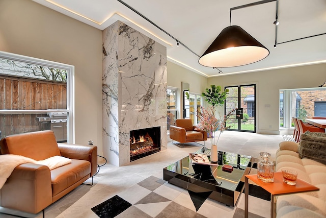 1202 Nantucket Dr, Houston, TX 77057 - tiled living area featuring a premium fireplace and track lighting