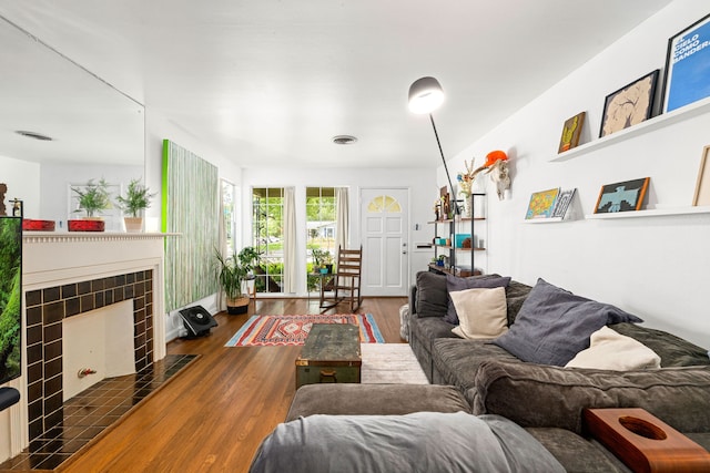 863 W 43rd St, Houston, TX 77018 - living room featuring wood finished floors and a tiled fireplace