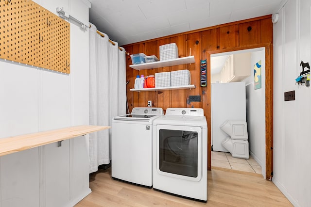 863 W 43rd St, Houston, TX 77018 - washroom featuring independent washer and dryer, light wood-style flooring, and wood walls