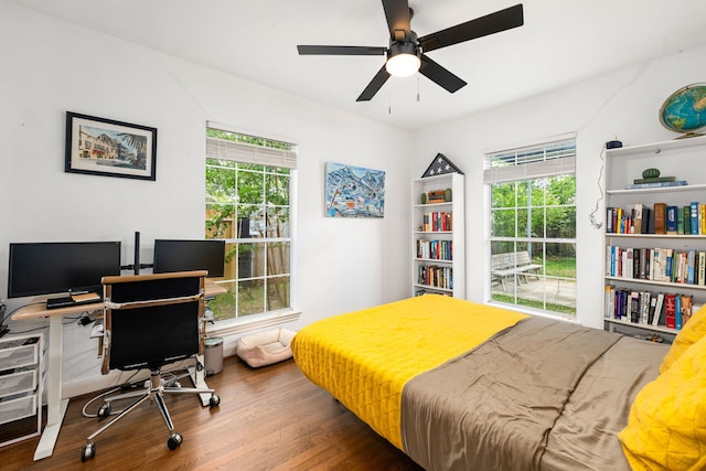 863 W 43rd St, Houston, TX 77018 - bedroom featuring multiple windows, wood finished floors, and a desk