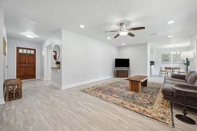 5402 Indigo St, Houston, TX 77096 - living room with baseboards, a ceiling fan, light wood finished floors, recessed lighting, and a chandelier