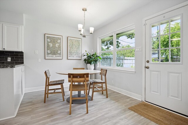 5402 Indigo St, Houston, TX 77096 - dining space featuring light wood-style flooring, baseboards, and a chandelier