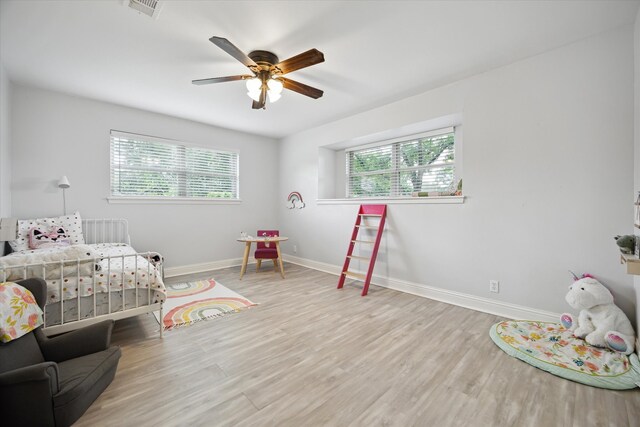 5402 Indigo St, Houston, TX 77096 - bedroom with wood finished floors, baseboards, and ceiling fan