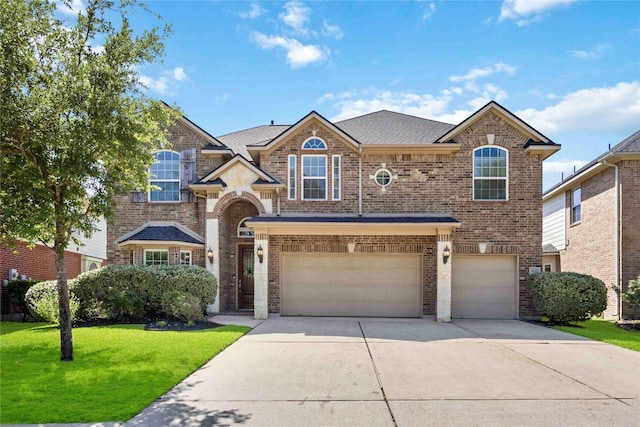 traditional-style house with a garage, brick siding, a front lawn, and driveway