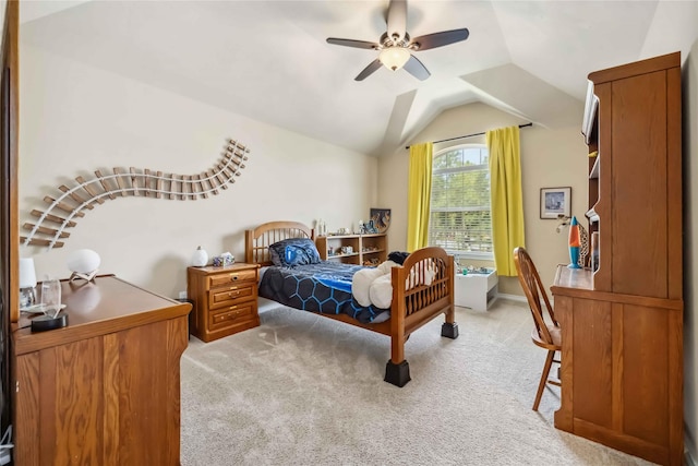 carpeted bedroom featuring lofted ceiling and a ceiling fan