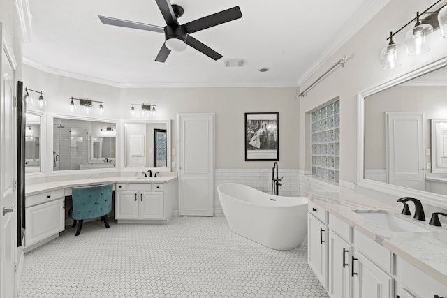 6503 Ambercrest Ct, Spring, TX 77389 - bathroom featuring a freestanding tub, two vanities, a ceiling fan, crown molding, and a wainscoted wall