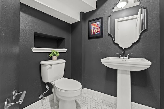6503 Ambercrest Ct, Spring, TX 77389 - half bathroom with toilet, baseboards, and tile patterned flooring