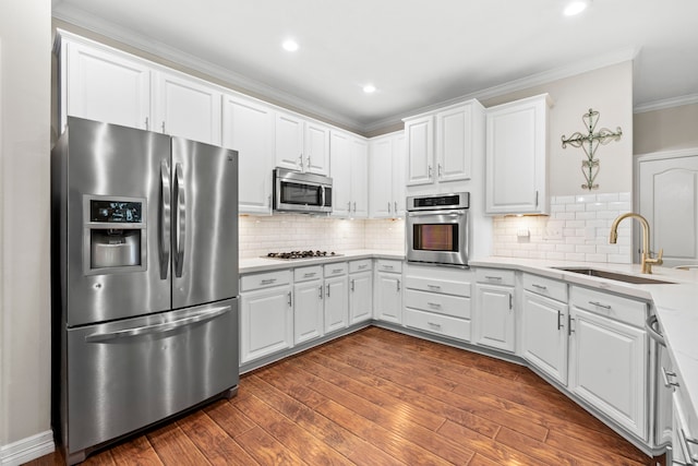 6503 Ambercrest Ct, Spring, TX 77389 - kitchen featuring stainless steel appliances, a sink, crown molding, white cabinets, and light countertops