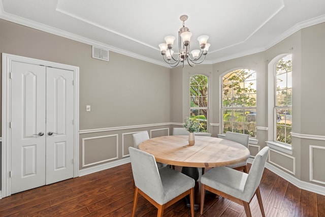 6503 Ambercrest Ct, Spring, TX 77389 - dining area with a tray ceiling, dark wood-style flooring, a chandelier, a wainscoted wall, and crown molding