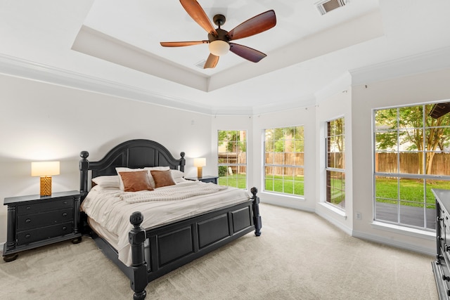 6503 Ambercrest Ct, Spring, TX 77389 - bedroom featuring a raised ceiling, light carpet, and a ceiling fan