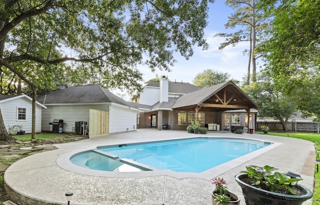 6503 Ambercrest Ct, Spring, TX 77389 - view of swimming pool with a patio, a grill, and a pool with connected hot tub