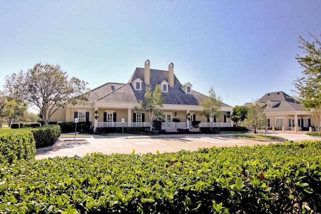 3119 Five Oaks Dr, Missouri City, TX 77459 - rear view of house with stucco siding and a chimney