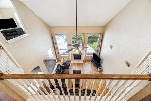 3119 Five Oaks Dr, Missouri City, TX 77459 - staircase with a ceiling fan, wood finished floors, and a textured wall