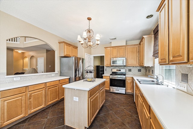 3119 Five Oaks Dr, Missouri City, TX 77459 - kitchen with appliances with stainless steel finishes, a sink, a chandelier, backsplash, and light countertops