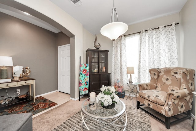 9703 Tipton Sands Dr, Humble, TX 77396 - living area featuring carpet, baseboards, and arched walkways