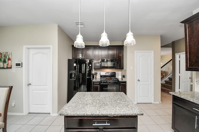 9703 Tipton Sands Dr, Humble, TX 77396 - kitchen with black appliances, light tile patterned floors, and dark brown cabinetry