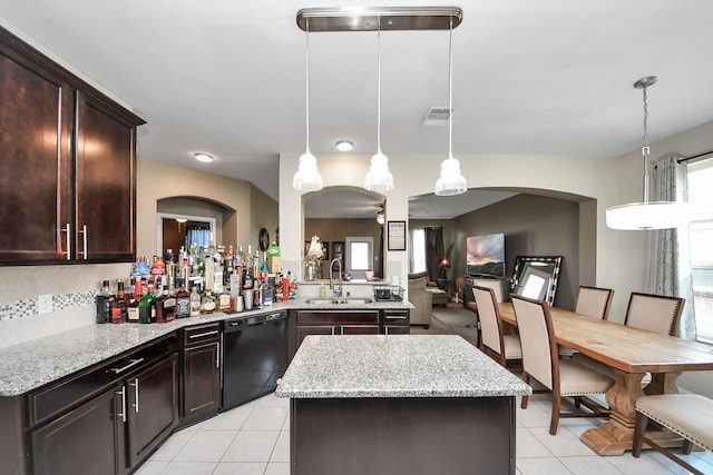 9703 Tipton Sands Dr, Humble, TX 77396 - kitchen featuring black dishwasher, a sink, arched walkways, dark brown cabinets, and light tile patterned floors