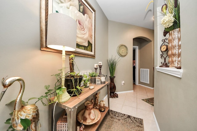9703 Tipton Sands Dr, Humble, TX 77396 - hall featuring arched walkways, light tile patterned floors, and baseboards
