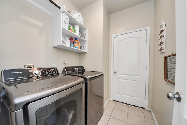9703 Tipton Sands Dr, Humble, TX 77396 - laundry area featuring light tile patterned floors, washer and dryer, and baseboards