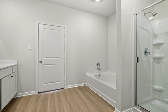 377 Tejas Trl, Waller, TX 77484 - full bathroom featuring a stall shower, wood finished floors, and baseboards