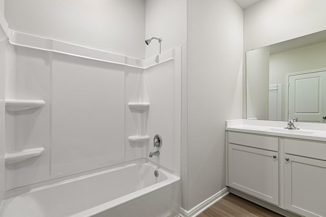 377 Tejas Trl, Waller, TX 77484 - full bathroom featuring shower / bath combination, wood finished floors, vanity, and baseboards