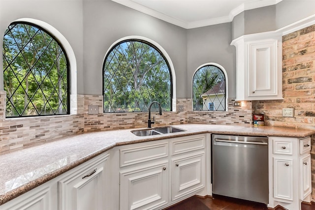 3230 Ivy Falls Dr, Houston, TX 77068 - kitchen with stainless steel dishwasher, a sink, backsplash, white cabinets, and ornamental molding
