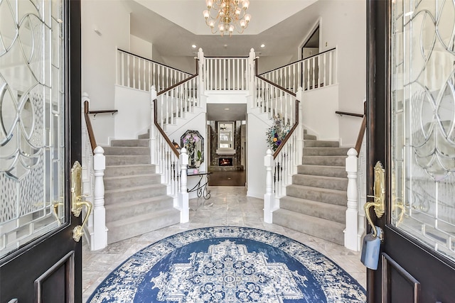 3230 Ivy Falls Dr, Houston, TX 77068 - foyer with a chandelier, stairs, light marble finish flooring, recessed lighting, and a high ceiling