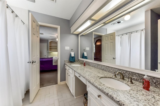 3230 Ivy Falls Dr, Houston, TX 77068 - ensuite bathroom with ceiling fan, double vanity, brick patterned floors, and baseboards