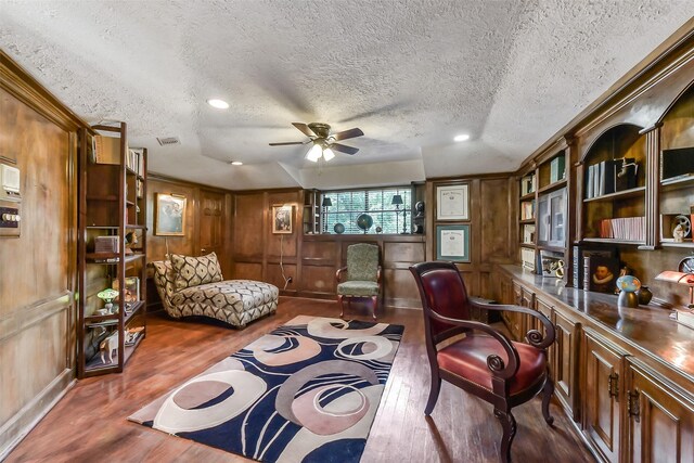 3230 Ivy Falls Dr, Houston, TX 77068 - sitting room with wood finished floors, ceiling fan, a textured ceiling, wood walls, and ornamental molding