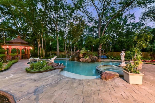 3230 Ivy Falls Dr, Houston, TX 77068 - view of pool featuring a gazebo, a pool with connected hot tub, a patio, fence, and view of wooded area