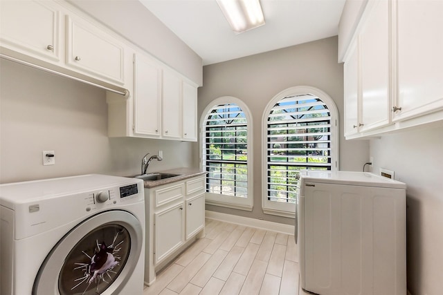 3230 Ivy Falls Dr, Houston, TX 77068 - washroom featuring separate washer and dryer, cabinet space, baseboards, and light wood-type flooring