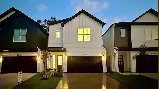 1918 Hoskins Dr, Houston, TX 77080 - view of front of home with a garage, concrete driveway, and board and batten siding
