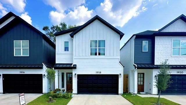 1918 Hoskins Dr, Houston, TX 77080 - modern farmhouse featuring a garage, concrete driveway, board and batten siding, a standing seam roof, and metal roof