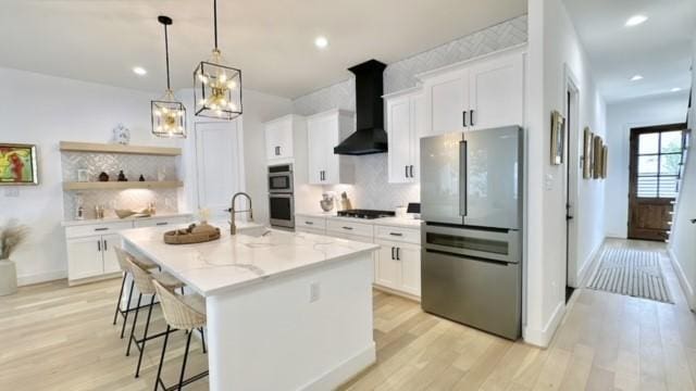 1918 Hoskins Dr, Houston, TX 77080 - kitchen with stainless steel appliances, wall chimney range hood, light wood-style floors, decorative backsplash, and recessed lighting