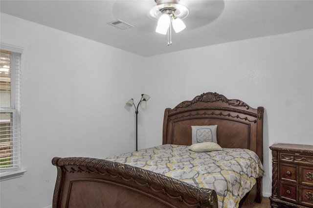 bedroom featuring baseboards and ceiling fan